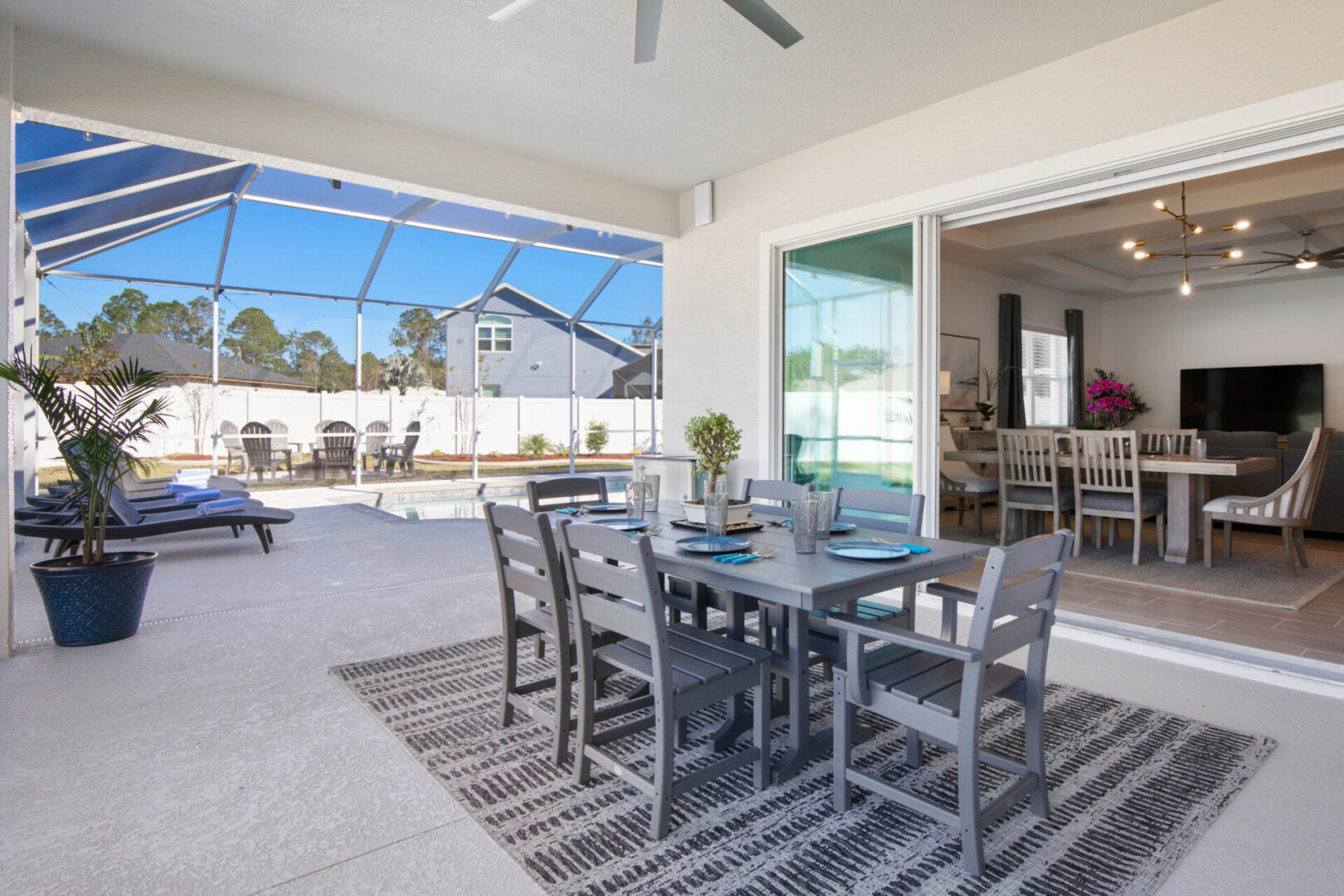 A patio with chairs and table in the middle of it