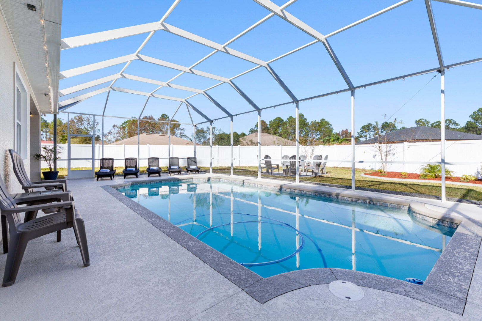 A swimming pool with chairs and tables in it