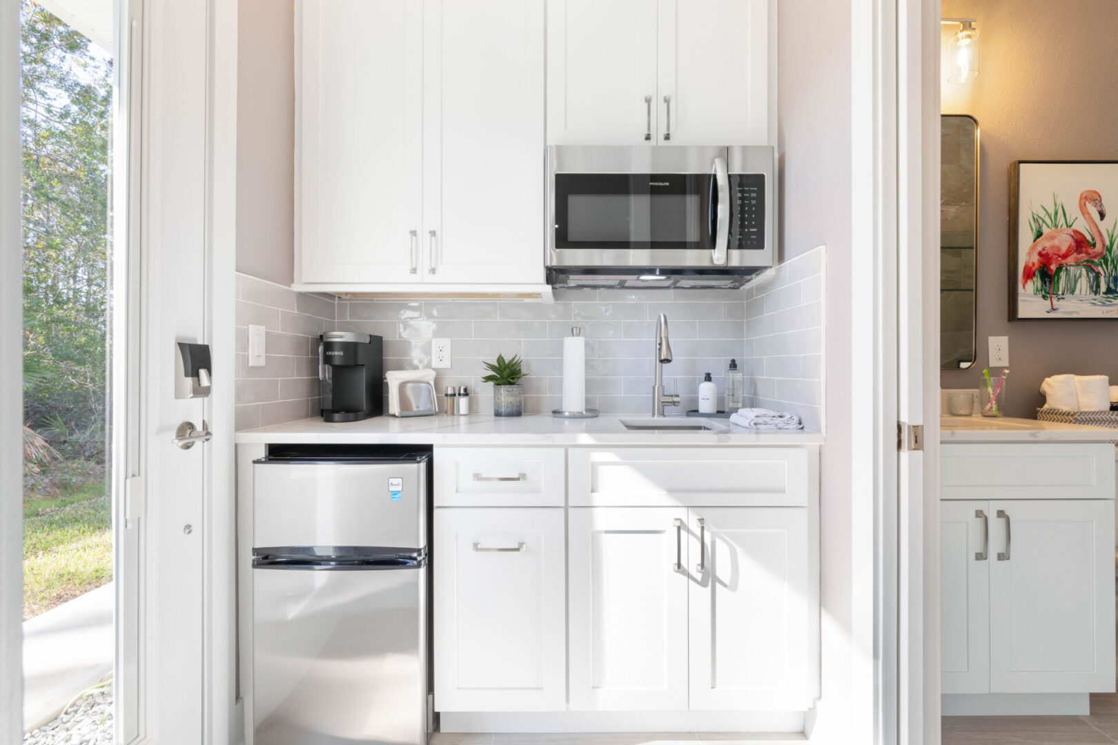 A kitchen with white cabinets and stainless steel appliances.